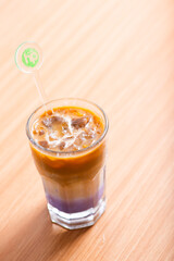 A Cup of latte served with syrup
