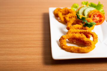 Deep fried onion rings served with tartar sauce and chili sauce