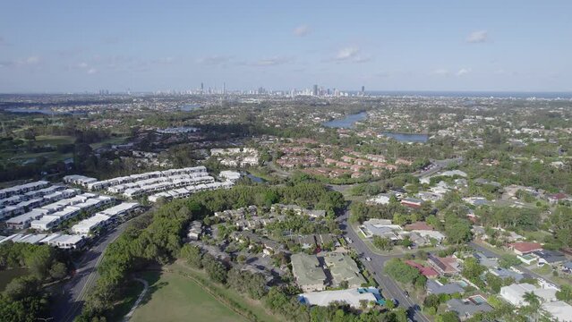 Lakefront Houses With Distant View Of Coastal Skyline In Robina Suburb Of Gold Coast In Queensland. wide aerial