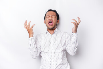 Naklejka premium A portrait of an Asian man wearing a white shirt isolated by white background looks depressed