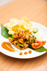 A Plate of indonesian salad, gado gado served with peanut sauce