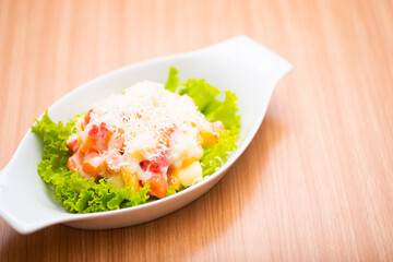 A Serving of healthy salad topped with mayonaise
