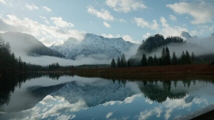 Beautiful reflection of the Austrian Alps in an alpine lake.
