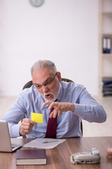 Fototapeta premium Old male boss working at workplace