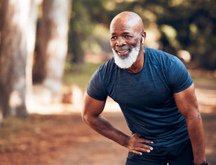 Black man, break from running and relax with fitness, vitality and cardio, senior runner in the park. Exercise, earpods and listen to music for motivation, tired with endurance and health outdoor