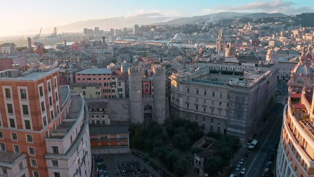 Aerial at sunset toward historic Walls of Barbarossa (Porta Soprana), Genoa