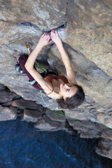 beautiful girl climbs the rock..
