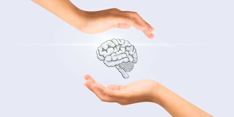 A human brain between two palms on gray isolated background. Healthy brain concept. Disease...