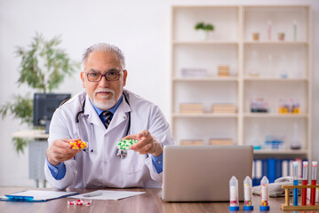 Old male doctor pharmacist in drugs synthesis concept