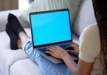 Woman, home and laptop with green screen on couch for streaming internet, website or news. Person with technology mockup on sofa for learning, education course and search to watch movie with wifi