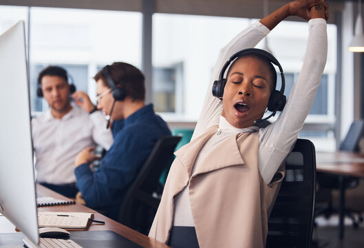 Tired Black Woman, Yawning And Stretching In Call Center For Break In Customer Services Or Desktop Support At Office. African American Female Exhausted Consultant In Arm Stretch From Telemarketing