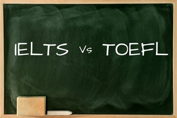Word IELTS vs. TOEFL in a Green Chalkboard background. Test of English as a Foreign Language exams....