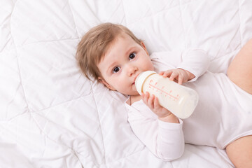 cute baby on blanket with baby bottle, card. space for text, banner