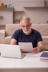 Old male employee working from home during pandemic