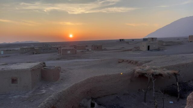 winter sunset in desert horizon in Iran Middle east
dry hot climate oasis in  abandoned rural area pomegranate garden qanat spring water system and wide landscape of the horizon make a golden time