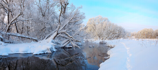 Winter beautiful morning landscape with snow covered trees and forest calm river