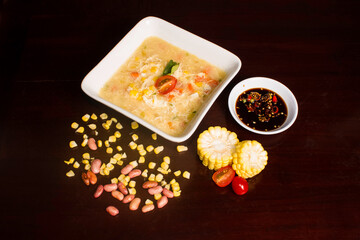 hot corn soup served with soy sauce and red chilies captured frome above 