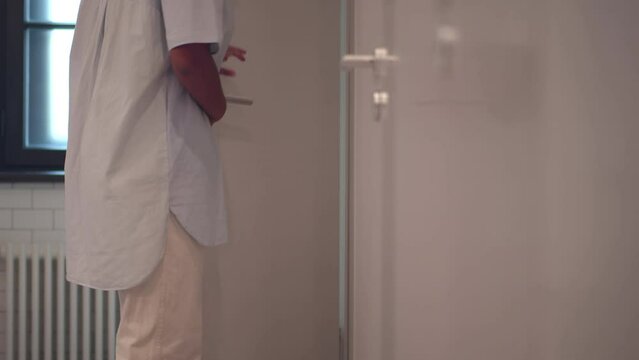 Cropped shot African-American woman feel pain with diarrhea in the restroom. Realtime