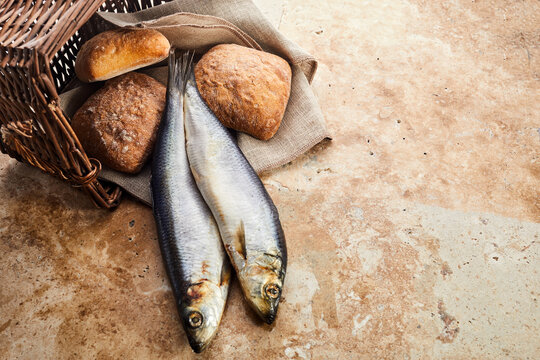 Christianity background. Loaves of bread and two fish in a basket.
