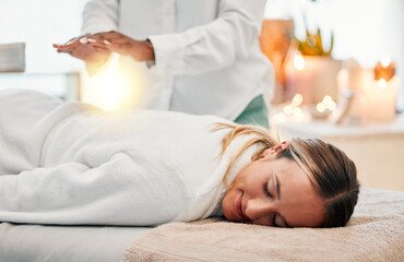 Relax, reiki and woman on bed at spa for chakra therapy with light energy and holistic medicine....