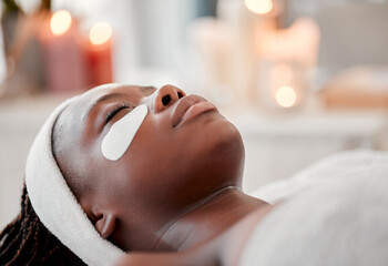 Eyes, patch and black woman face at spa, beauty and relax dermatology for aesthetic glow. Female,...