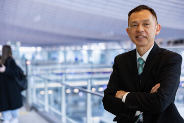 Asian middle-class businessman heading for an overseas business trip in the airport lobby.