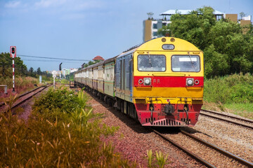 Naklejka premium Passenger train by diesel locomotive on the railway.