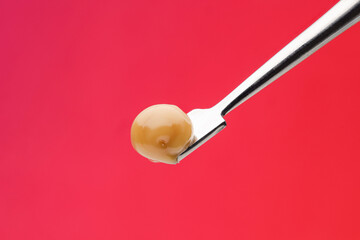 Live Rosin on Dab tool with a red Background