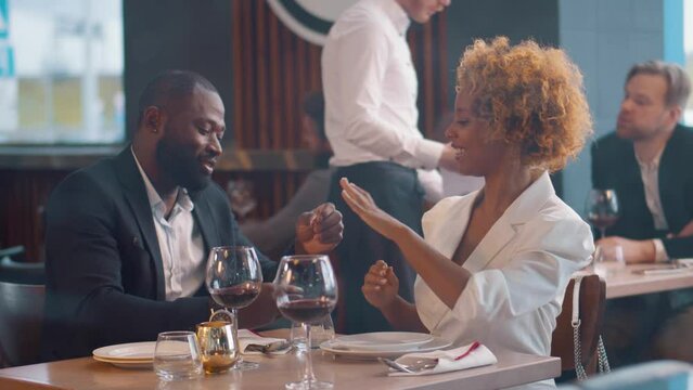 Young man makes proposal to his beloved girl during a romantic dinner. 