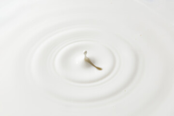 Milk circles ripple, splash waves from top view of water droplets background.