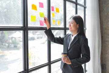 Businesswoman chinese asian people explaining diagram and writing on note paper Business planning ideas and finding flaws to prevent errors in work