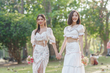 Fototapeta na wymiar Two pretty asian friends woman picnic at park outdoor in relax time holiday, holiday recreation concept.