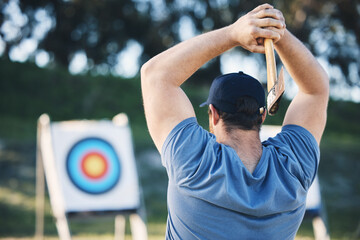 Man axe throwing at sports range, archery training or practice with board circle for action, game...