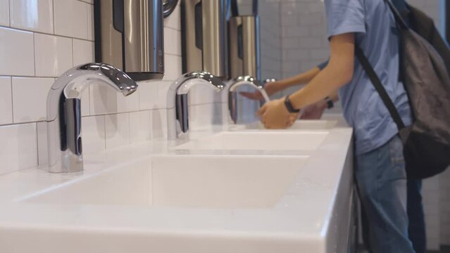 Children wash hands at school bathroom. Realtime