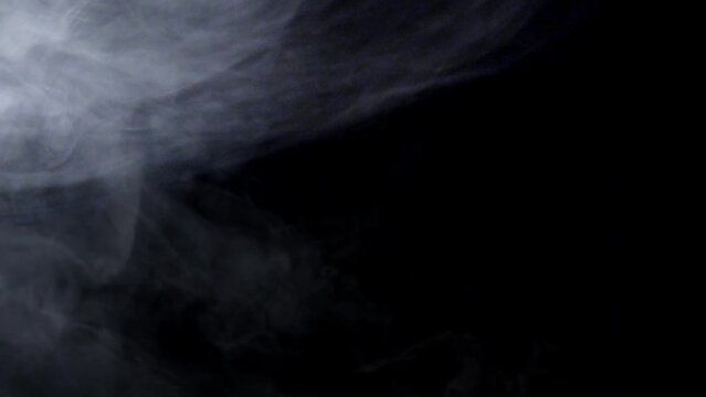 white smoke blowing isolated around dark background