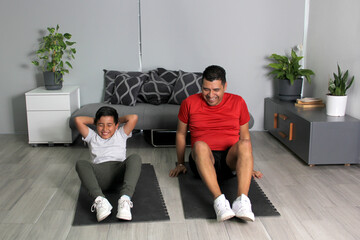 Overweight Latino dad and son exercise at home to lose weight and be healthy to avoid diseases such...