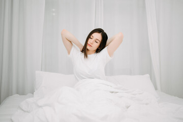 Image of beautiful woman resting in white bed at bedroom. in morning . Lifestyle at home concept.