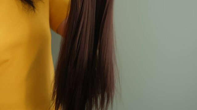 woman holds a bright brunette wig in her hands. Womens beauty concept