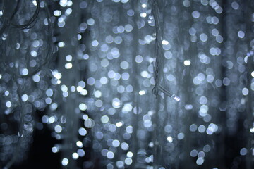 Abstract blue white light bokeh  texture like firefly on black background , Festive defocused lights.