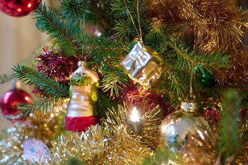 Decorated Christmas tree with balls, garlands, lights and a crocodile.