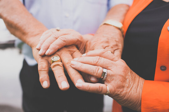 Weathered hands of an elderly couple.
