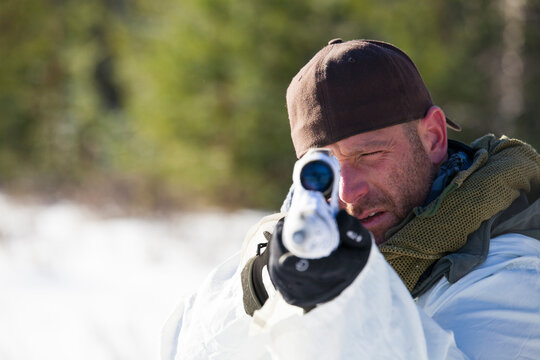 A hunter takes aim with his rifel.