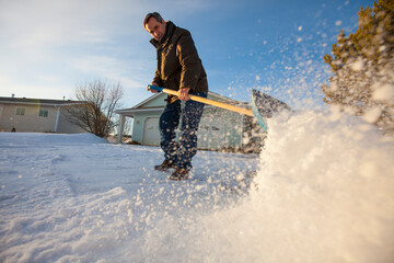A man shovels snow off his driveway in northern Alberta.