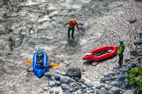 A Group Of Three Men Stop For A Break While Packrafting The Chehalis River, British Columbia, Canada