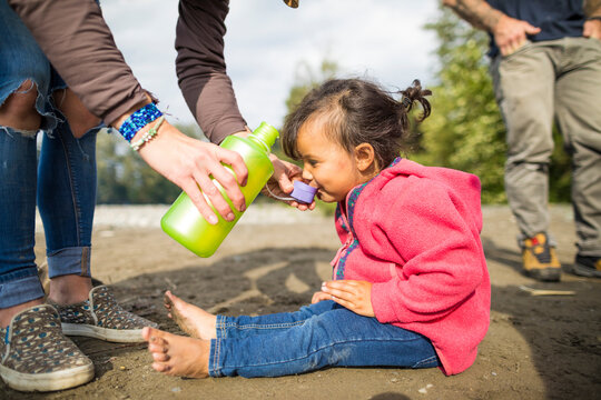 Toddler drinking from lid of canteen