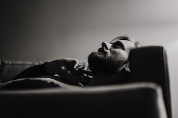 Young handsome man with long dark hair, fashion portrait.