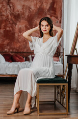 Fototapeta premium beautiful young pregnant woman in brown studio