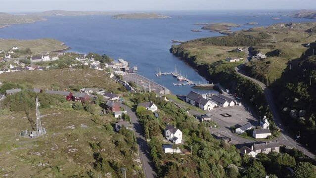 Drone shot of the village of Tarbert, featuring the Isle of Harris Distillery. Filmed on the Isle of Harris, part of the Outer Hebrides of Scotland.