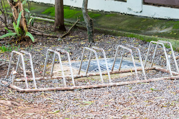 old commercial bike rack in an outdoor environment empty with no bicycles concept biking accessory