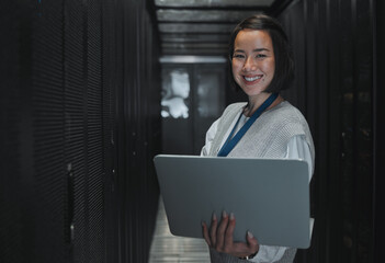 Woman with laptop, server room and information technology, smile in portrait with engineer and...